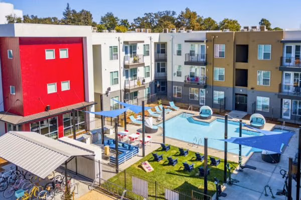 Outdoor courtyard with pool and shaded seating at Campus Walk in Chico