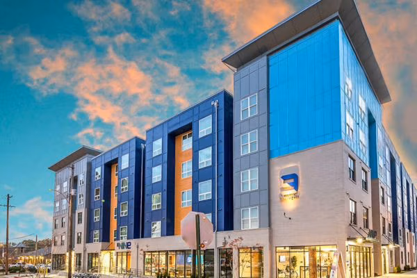 The Nine student apartments featuring glass façade and retail storefront